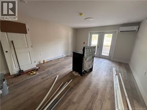 Hampton apartment for rent - A room with wooden flooring and a black trash bin in the middle.
