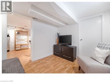 Waterloo apartment for rent - A living room with a grey couch and a wooden floor.