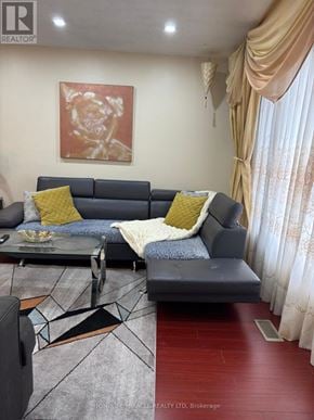 Mississauga (Malton) apartment for rent - A living room with a grey couch and a coffee table.