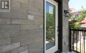 Mississauga (Applewood) townhouse for rent - A realtor sign is on the wall of a house.