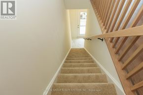 Mississauga (Applewood) townhouse for rent - A staircase with beige carpeted steps and wooden handrails.