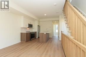 Mississauga (Applewood) townhouse for rent - A spacious living room with a staircase on the right side.