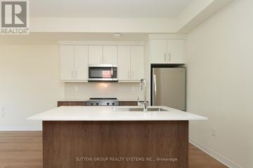 Mississauga (Applewood) townhouse for rent - A kitchen with a white counter top and a microwave above it.