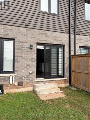 Niagara Falls (Morrison) townhouse for rent - A house with a brown wooden fence and a glass door.