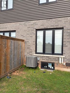 Niagara Falls (Morrison) townhouse for rent - A house with a brown fence and a window with a sign on it.