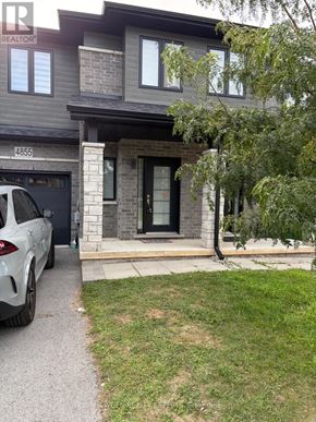 Niagara Falls (Morrison) townhouse for rent - A grey house with a white car parked in front.