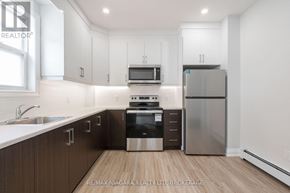 St. Catharines (E. Chester) apartment for rent - A kitchen with brown cabinets and stainless steel appliances.