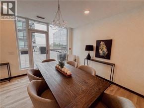 Kitchener condo for rent - A dining room with a wooden table and chairs.