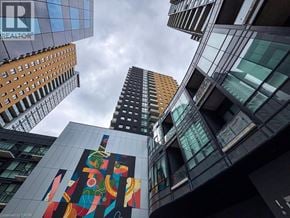 Kitchener condo for rent - A tall building with a mural on the side.
