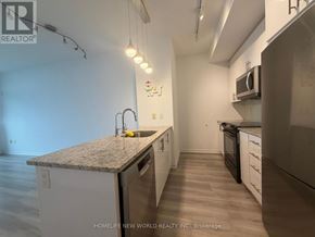 Toronto (Henry Farm) condo for rent - A kitchen with a granite countertop and white cabinets.
