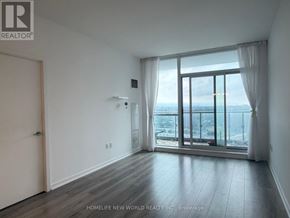 Toronto (Henry Farm) condo for rent - A room with a sliding glass door leading to a balcony with a view of the city.