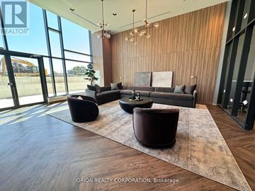 Pickering (Bay Ridges) condo for rent - A living room with a couch, two chairs and a rug.