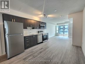 Pickering (Bay Ridges) condo for rent - A kitchen with a refrigerator, microwave, oven, and sink.