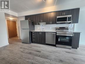 Pickering (Bay Ridges) condo for rent - A kitchen with a refrigerator, oven, and microwave.