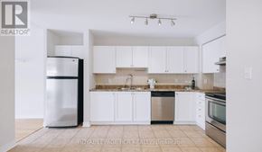 King (Schomberg) condo for rent - A kitchen with white cabinets and stainless steel appliances.