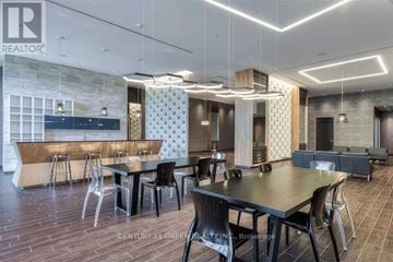 Toronto (Mimico) condo for rent - A modern dining room with a long table and chairs.