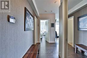 Toronto (Mimico) condo for rent - A hallway with a bench and a painting on the wall.