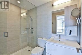 Toronto (Mimico) condo for rent - A bathroom with a toilet, sink, and shower.