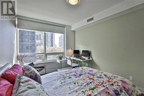 Toronto (Mimico) condo for rent - A bedroom with a bed, desk, and window.