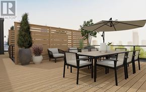 Ottawa multi-family for rent - A wooden deck with a table and chairs and a large umbrella.