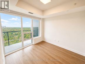 Toronto (North St. James Town) condo for rent - A room with a view of a cityscape through large windows.