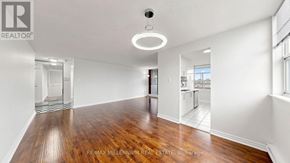 Brampton (Brampton 407 Corridor) condo for rent - A kitchen with white cabinets and a black stove top oven.
