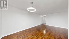 Brampton (Brampton 407 Corridor) condo for rent - A balcony with a red chair and a brick wall.