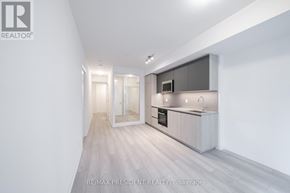 Toronto (Waterfront Communities) condo for rent - A modern kitchen with a sink, stove, and refrigerator.