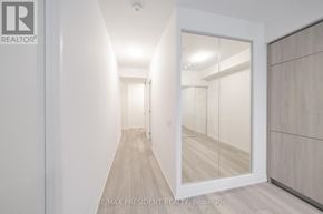 Toronto (Waterfront Communities) condo for rent - A hallway with a glass door leading to another room.