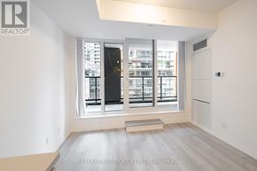 Toronto (Waterfront Communities) condo for rent - A room with a large window and a view of a cityscape.