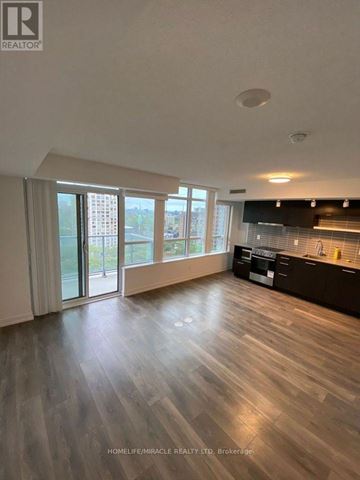 Toronto (Church-Yonge Corridor) condo for rent - A spacious living room with wooden flooring and large windows.