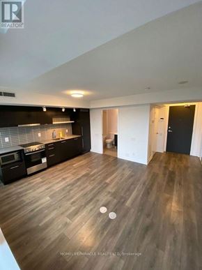 Toronto (Church-Yonge Corridor) condo for rent - A spacious kitchen with dark wood flooring and modern appliances.