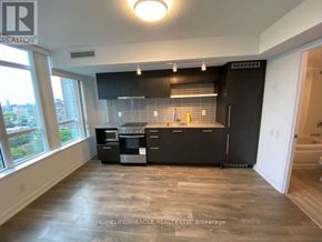 Toronto (Church-Yonge Corridor) condo for rent - A kitchen with black cabinets and a stainless steel dishwasher.