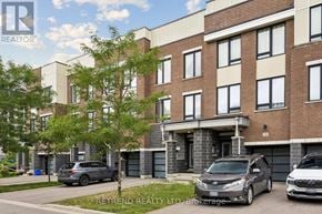Vaughan townhouse for rent - A modern apartment building with cars parked in front.