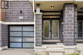 Vaughan townhouse for rent - A house with a grey front and a black door.