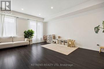 Vaughan townhouse for rent - A living room with a white sofa and a wooden bench.
