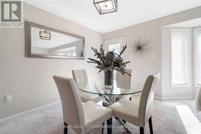 Milton (Wi Willmott) townhouse for rent - A dining room with a glass table and chairs.