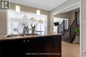 Milton (Wi Willmott) townhouse for rent - A kitchen with a sink, a counter, and a staircase in the background.