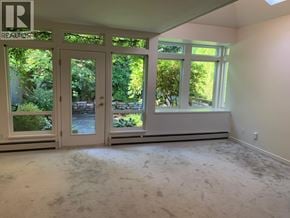 Vancouver apartment for rent - A room with a window and a door leading outside.
