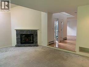 Vancouver apartment for rent - A living room with a fireplace and a sliding glass door.