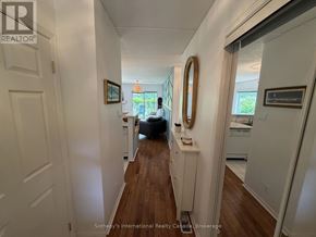 Collingwood townhouse for rent - A hallway with a couch and a mirror on the wall.