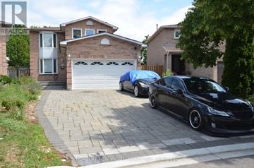 Markham (Raymerville) apartment for rent - A black car is parked in front of a garage.
