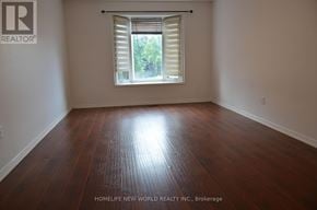 Markham (Raymerville) apartment for rent - A room with wooden flooring and a window with blinds.