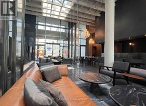 Vaughan (Vaughan Corporate Centre) condo for rent - A modern waiting area with a brown leather couch and a glass ceiling.