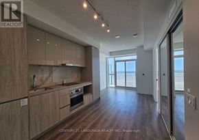 Vaughan (Vaughan Corporate Centre) condo for rent - A modern kitchen with wooden cabinets and a large window.