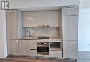 Vaughan (Vaughan Corporate Centre) condo for rent - A modern kitchen with wooden cabinets and a marble backsplash.