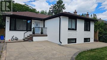 Oakville (Wo West) apartment for rent - A white house with a brown roof and a bicycle parked in front.