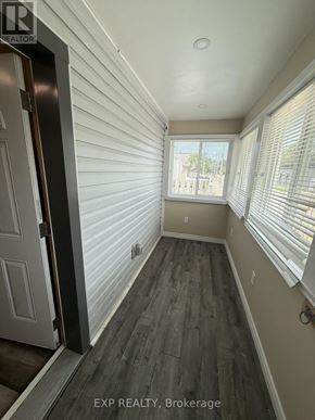 St. Catharines (Facer) apartment for rent - A hallway with wood flooring and white walls.