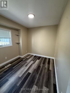 St. Catharines (Facer) apartment for rent - A room with wooden flooring and a window with blinds.