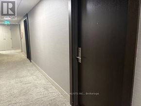 Mississauga (Hurontario) condo for rent - A hallway with a black door on the right and a white door on the left.